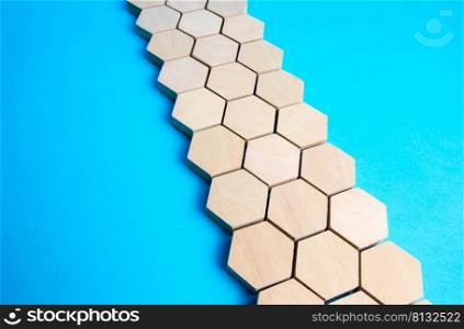 Chain of hexagons on a blue background. Moving forward. Abstraction. Structure, hierarchy. The concept of organization and strength. Unity and Consolidation. Orderly system. Stability, steadfastness.