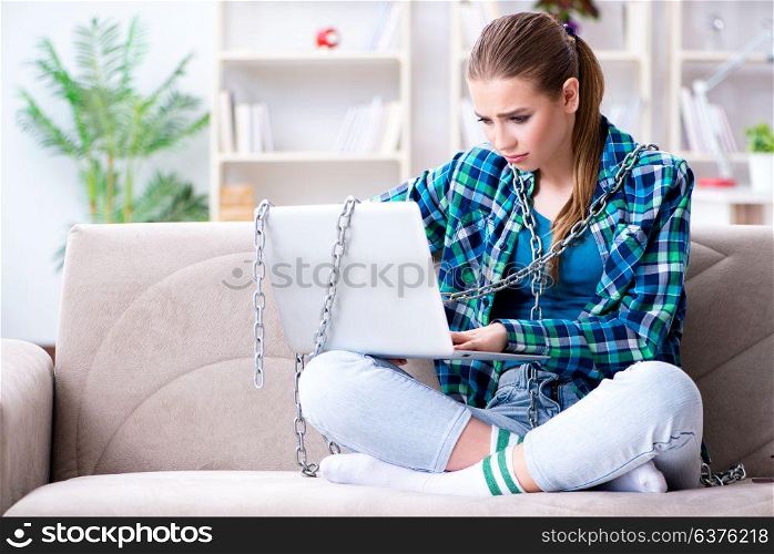 Chained female student with laptop sitting on the sofa. Chained female student with laptop sitting on the sofa