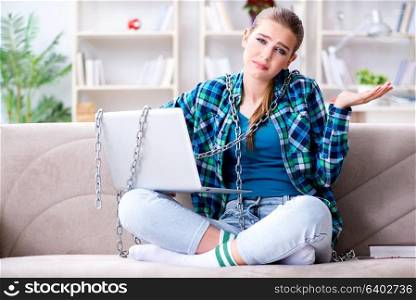 Chained female student with laptop sitting on the sofa. Chained female student with laptop sitting on the sofa