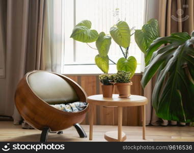 chair and round wooden coffee table against window near paneling wall