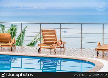 chair around outdoor swimming pool in hotel resort neary sea and beach