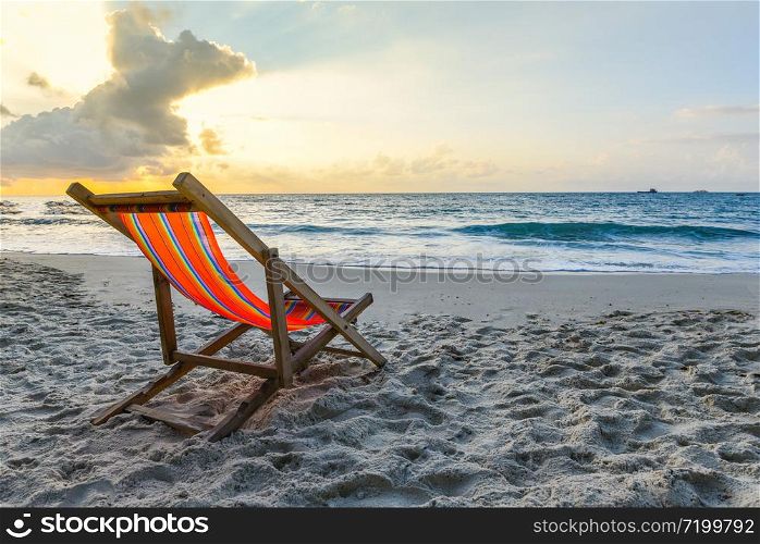 Chair beach on sand in the summer vacation nature travel beautiful summer landscape with / Tropical Holiday sunset or sunrise on the beach with sea and yellow sky ocean background