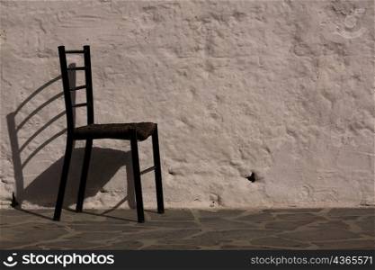 Chair next to a stone wall