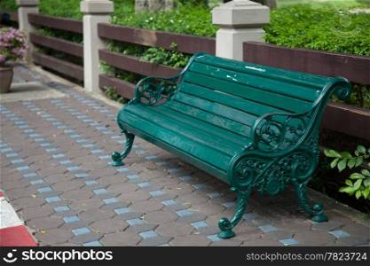 Chair of the bench in the park. Set on the sidewalk. All areas within the park.