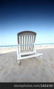 chair on sand and ocean background