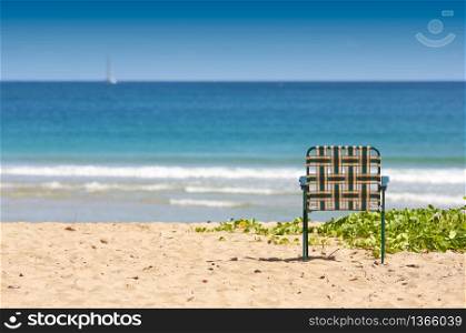 Chair sits on an inviting tropical shore.. Inviting Shore Abstract