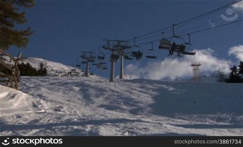 Chair ski lift with skiers over