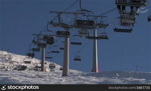 Chair ski lift with skiers over
