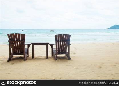Chairs and table. Located on the sandy beach. Attached to the sea during the holidays.