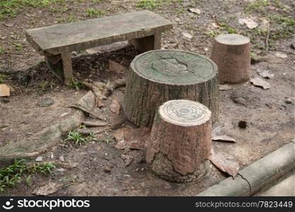 Chairs and tables made ??of stone like the trees, but imitation is placed in the garden.
