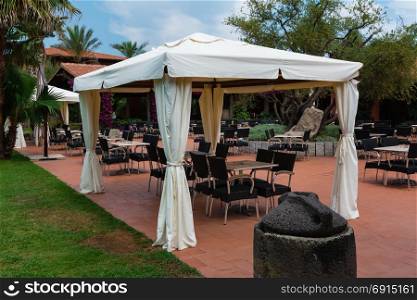 Chairs and Tables under Gazebo with White Tent