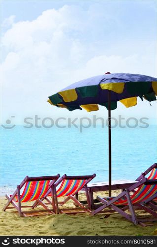 Chairs and umbrella at a sandy beach&#xA;