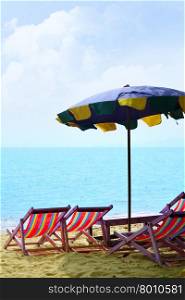 Chairs and umbrella at a sandy beach&#xA;
