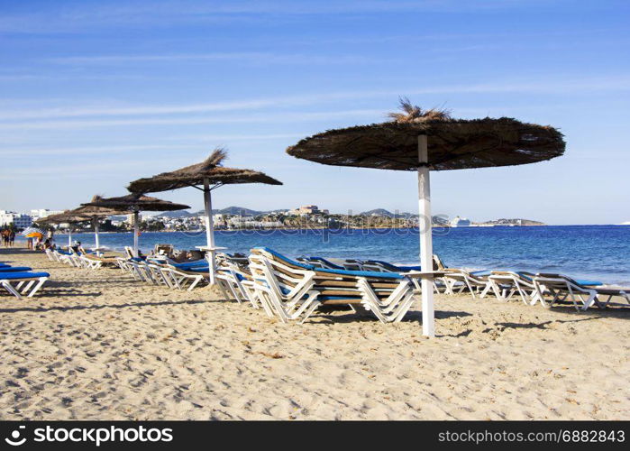 Chairs and umbrellas on a beautiful sandy beach at Ibiza