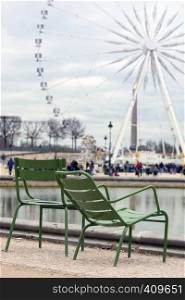 chairs for rest in the background of the Great Wheel on the Place de la Concorde in Paris. France