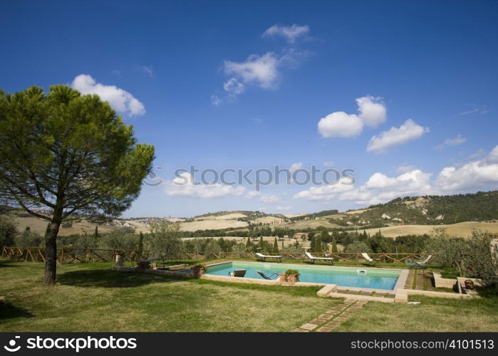 Chairs in the garden of a luxury country house in the famous tuscan hills, Italy.