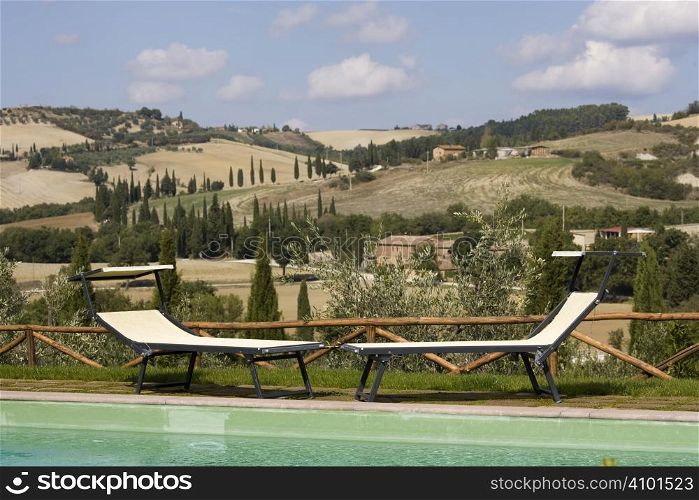 Chairs in the garden of a luxury country house in the famous tuscan hills, Italy.