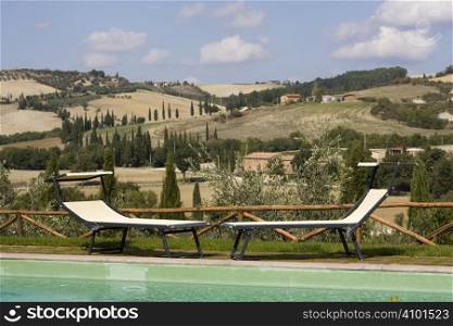 Chairs in the garden of a luxury country house in the famous tuscan hills, Italy.