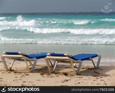 Chairs on the sand beach in island Barbados