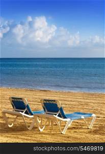 chaise lounges on a beach.