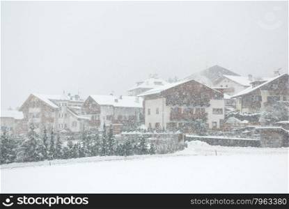Chalets, during a snowstorm, in Mals, Northern Italy