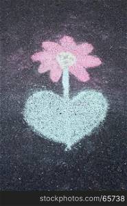chalk drawing flower on asphalt, road