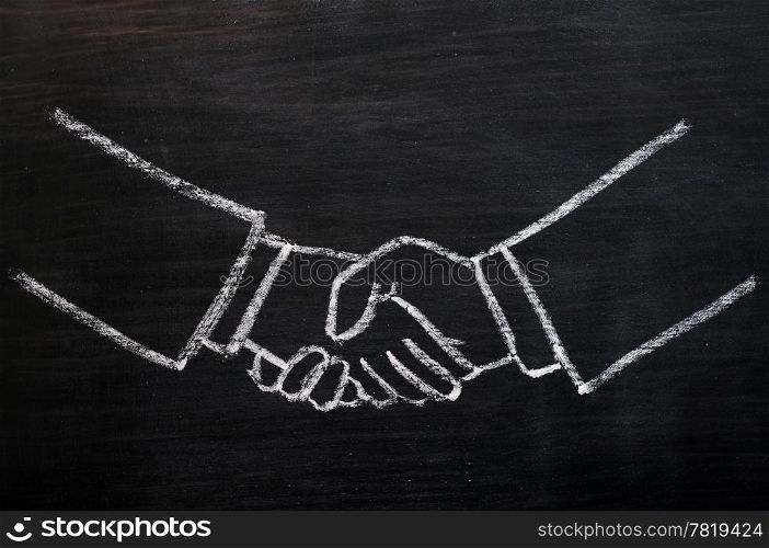 Chalk drawing of handshaking on a smudged blackboard
