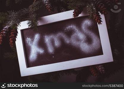 Chalkboard on the pine with &quot;Xmas&quot; word