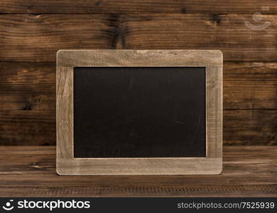 Chalkboard on wooden background. Vintage texture with copy space for your text