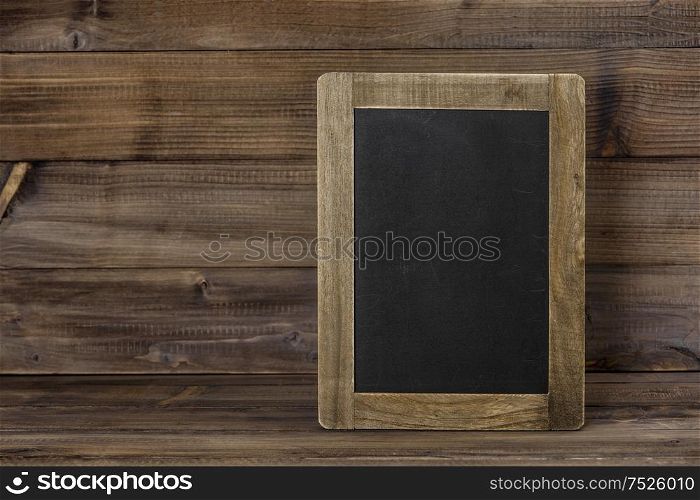 Chalkboard on wooden texture. Rustic background with copy space for your text. Vintage style toned picture
