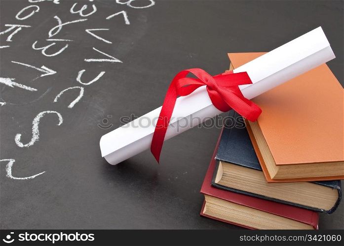 Chalkboard with a diploma and books