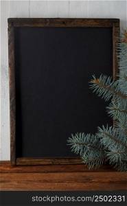 Chalkboard with christmas fir branches