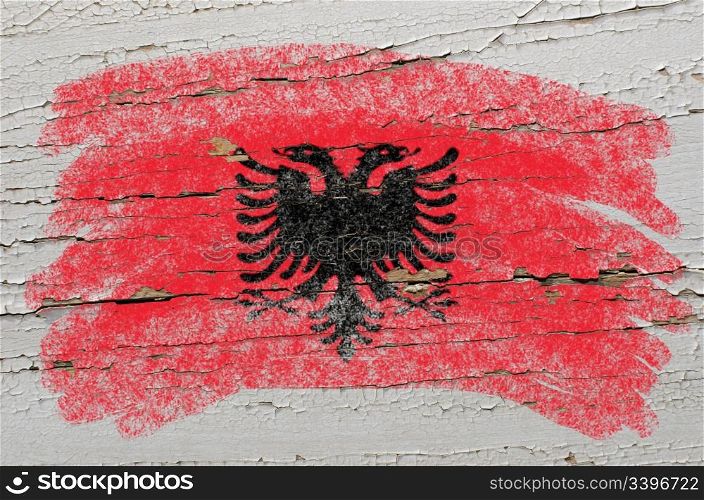 Chalky albanian flag painted with color chalk on grunge wooden texture