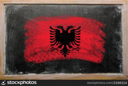 Chalky albanian flag painted with color chalk on old blackboard