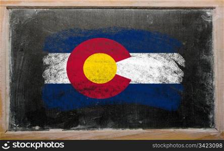 Chalky american state of colorado flag painted with color chalk on old blackboard