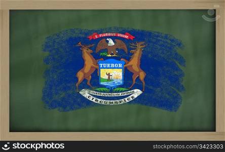 Chalky american state of michigan flag painted with color chalk on old blackboard