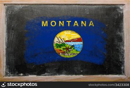 Chalky american state of montana flag painted with color chalk on old blackboard