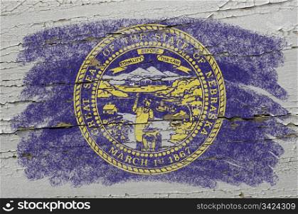Chalky american state of nebraska flag precisely painted with color chalk on grunge wooden texture