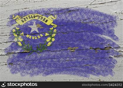 Chalky american state of nevada flag precisely painted with color chalk on grunge wooden texture