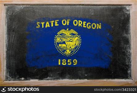 Chalky american state of oregon flag painted with color chalk on old blackboard