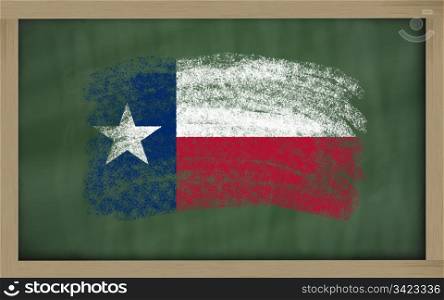 Chalky american state of texas flag painted with color chalk on old blackboard