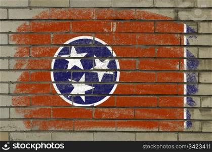 Chalky and grunge american state of tennessee flag painted with color chalk on brick wall