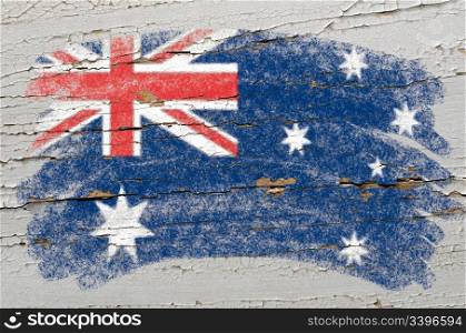 Chalky australian flag painted with color chalk on grunge wooden texture