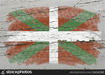 Chalky basque flag precisely painted with color chalk on grunge wooden texture