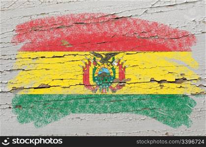 Chalky bolivian flag painted with color chalk on grunge wooden texture