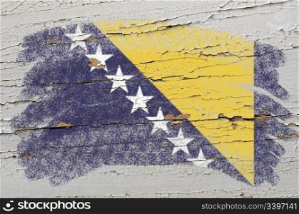 Chalky bosnia and herzegovina flag painted with color chalk on grunge wooden texture