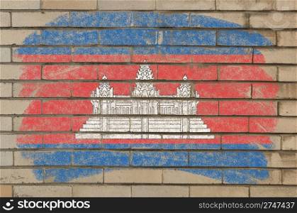 Chalky cambodian flag painted with color chalk on grunge old brick wall