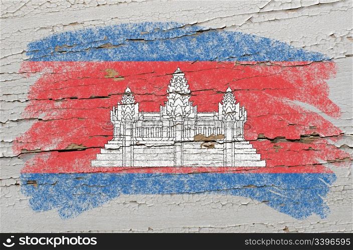 Chalky cambodian flag painted with color chalk on grunge wooden texture