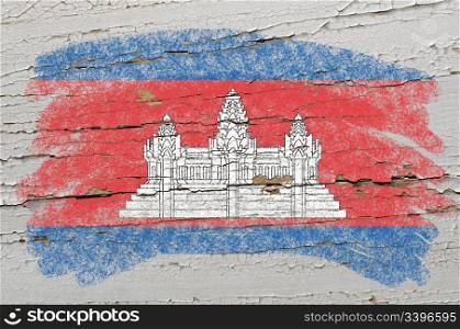 Chalky cambodian flag painted with color chalk on grunge wooden texture