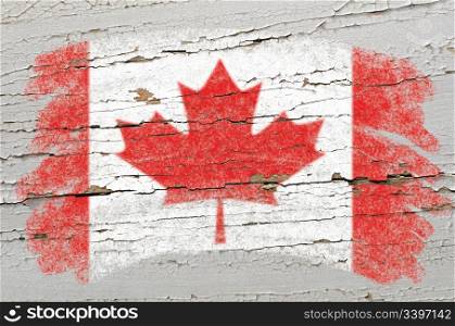 Chalky canadian flag painted with color chalk on grunge wooden texture